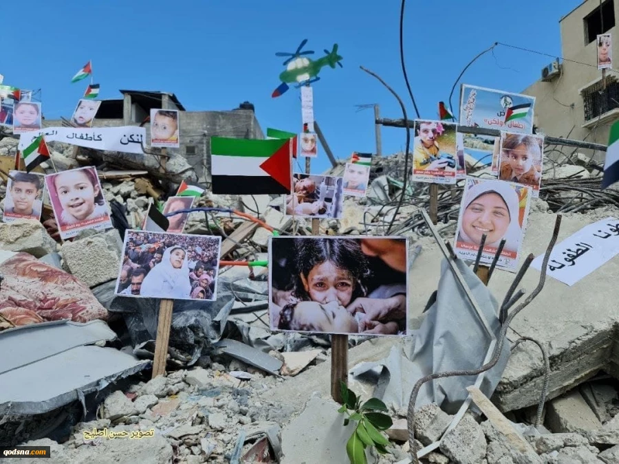 به همراه تصاویرنمایشگاه عکس کودکان و زنان شهید فلسطینی بر روی خرابه‌های خانه‌های مسکونی غزه 4