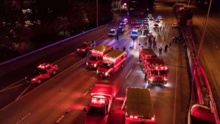 US Police officers confront crowds with flash-bang grenades and pepper spray