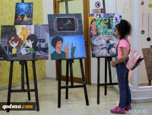 Visitors view artworks made by Palestinian children during exhibition in Gaza City
 5